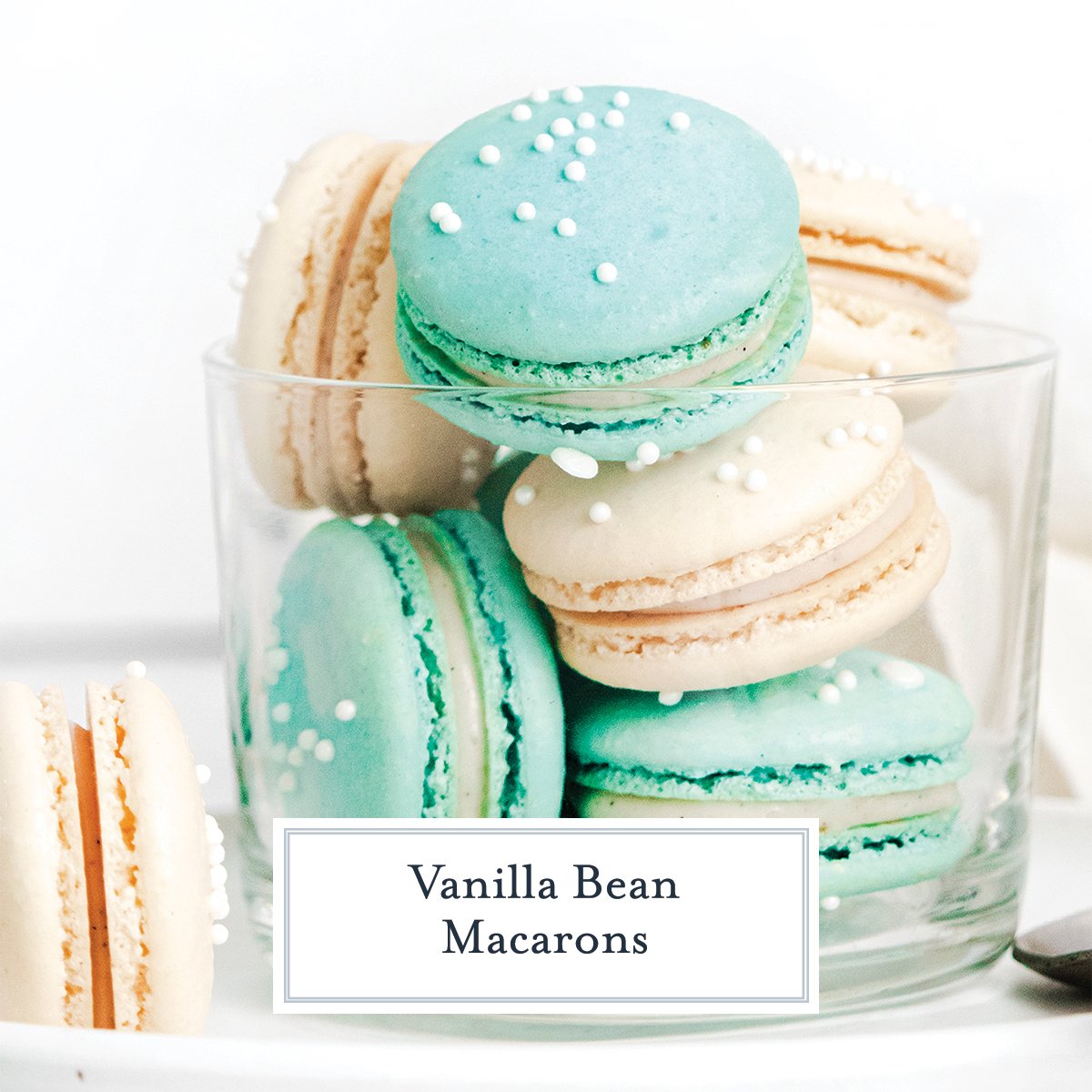 teal and white macarons in a glass 