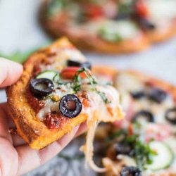 slice of sweet potato crust pizza with olives