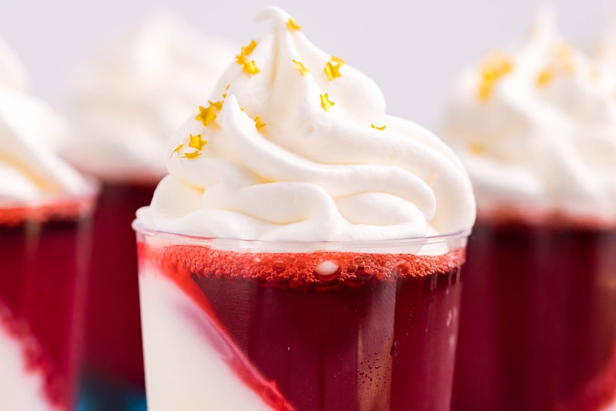 close up of whipped cream with gold star sprinkles 