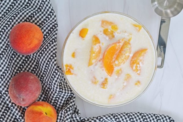 peaches and yogurt in a mixing bowl