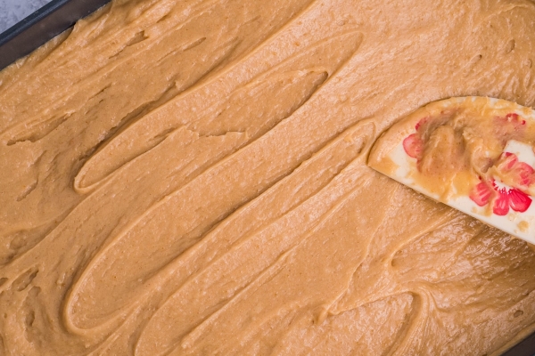 spreading cake batter into a baking dish