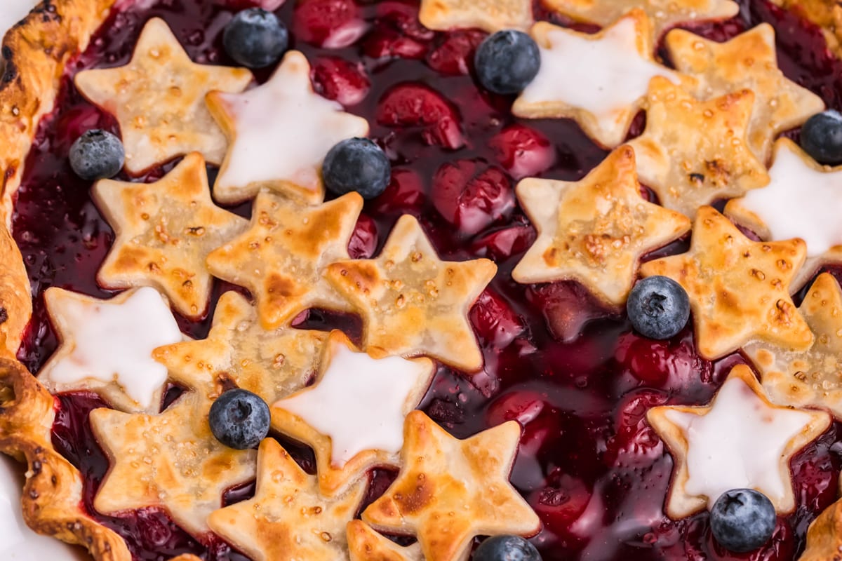 close up of cherry pie with stars and blueberries 