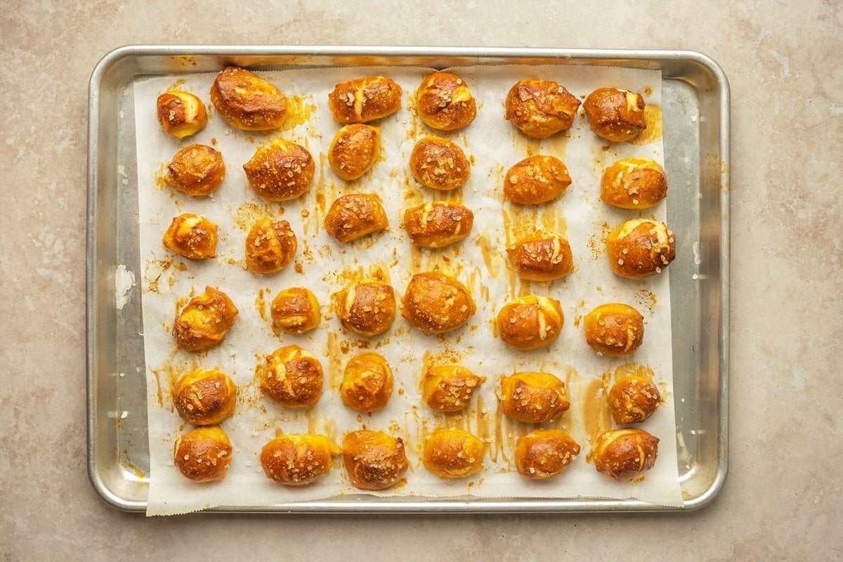 baked and browned soft pretzels on a baking sheet 