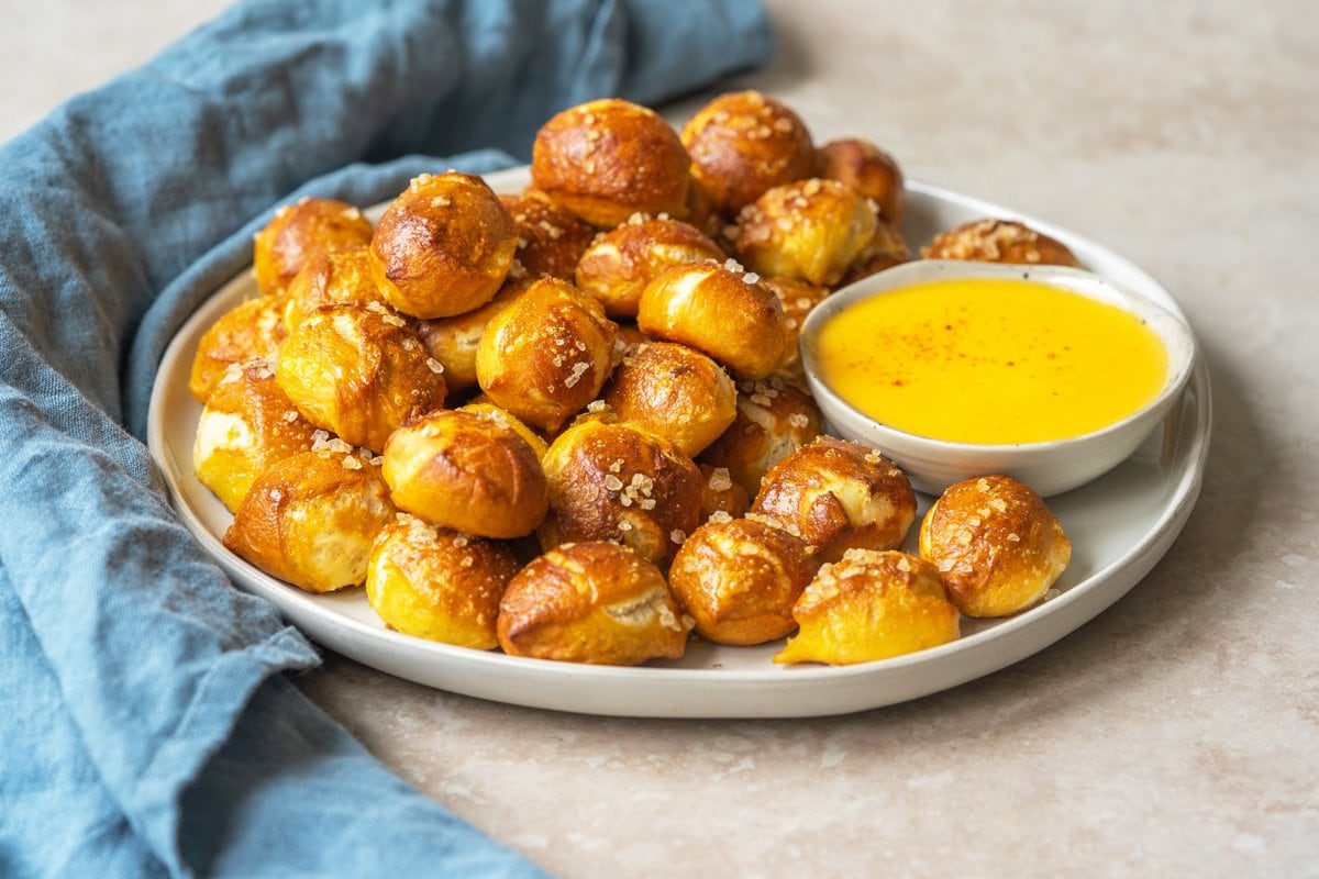 angle of soft pretzel bites with cheese sauce 