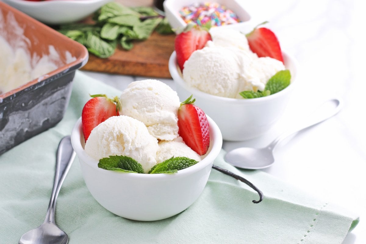 bowls of vanilla ice cream with fresh berries and mint 