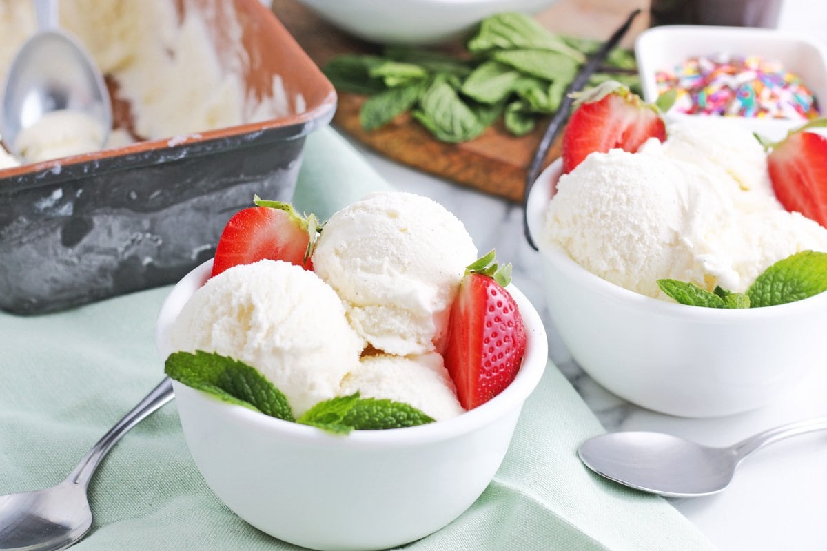 vanilla ice cream in bowls with toppings and mint 