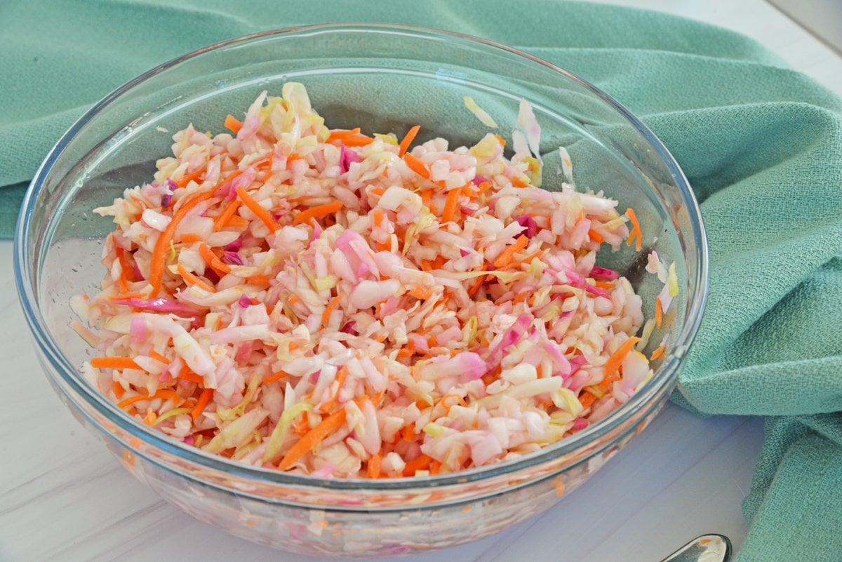 bowl of vinegar slaw with teal linen