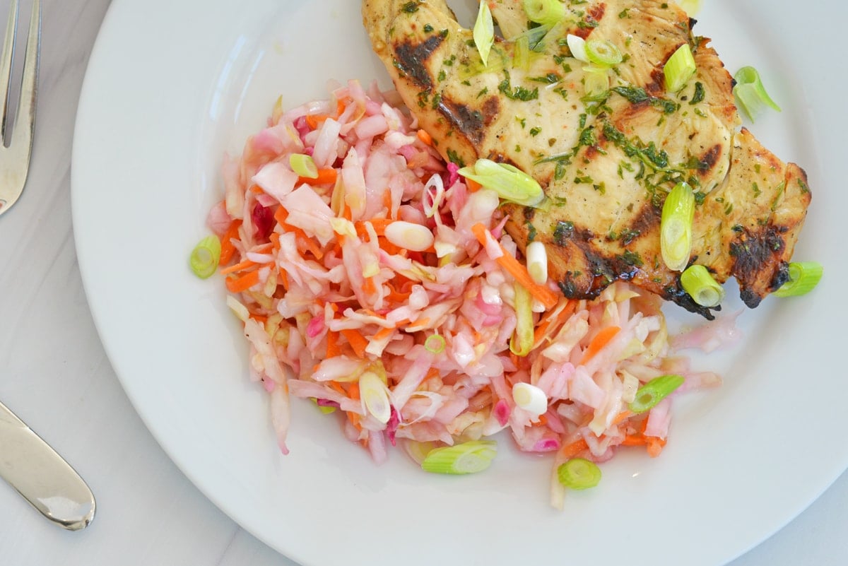 homemade coleslaw next to chicken 