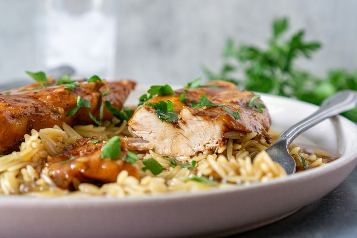 chicken breast cut in half over rice