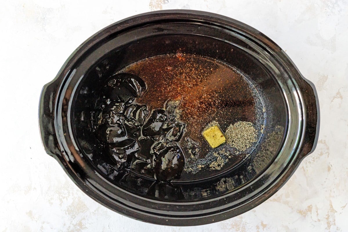 overhead of ingredients for balsamic sauce in a crock pot 