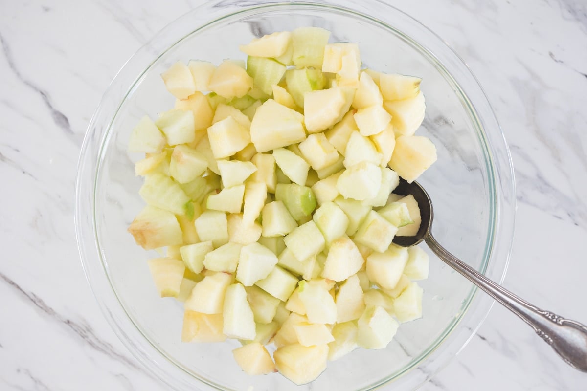 chopped apples in a clear mixing bowl 