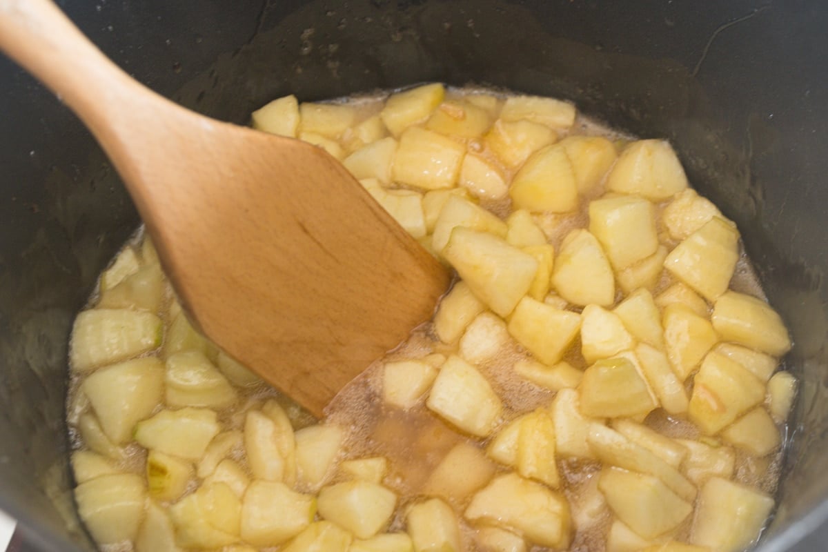 stirring apple pie filling in a saucepan 