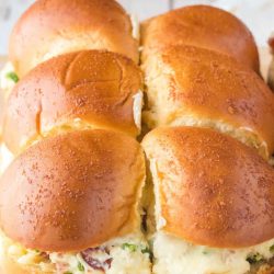 jalapeno popper chicken sliders on a wooden tray