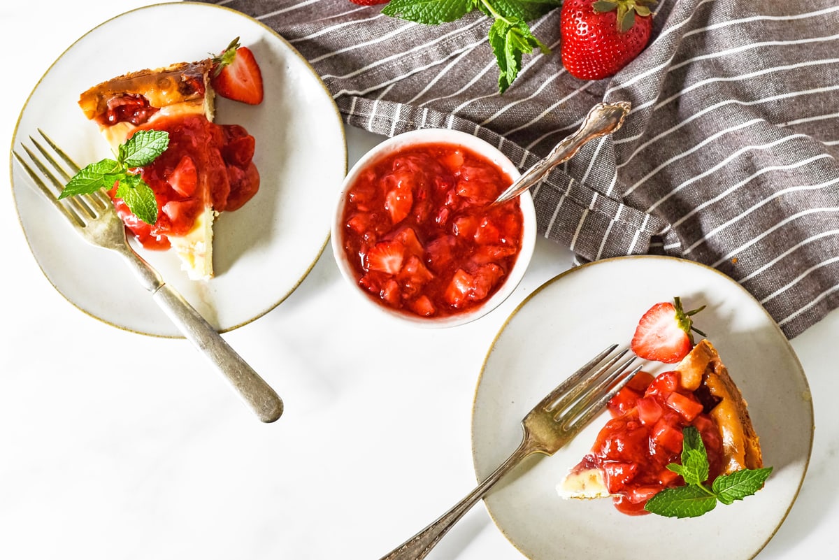 two slices of strawberry cheesecake with topping 