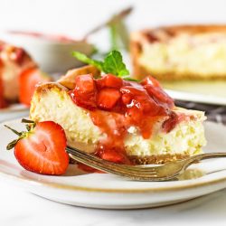 close up angle of cheesecake with strawberry topping