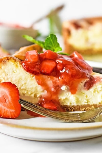 close up angle of cheesecake with strawberry topping