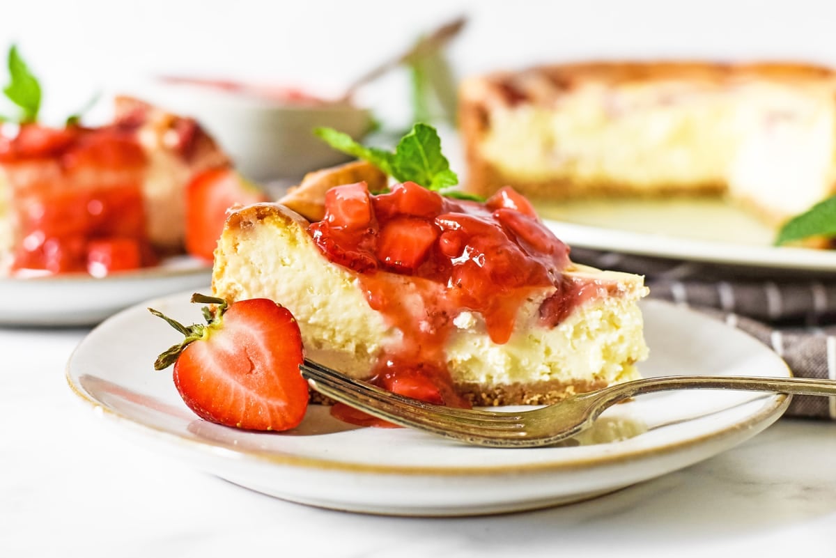 close up angle of cheesecake with strawberry topping