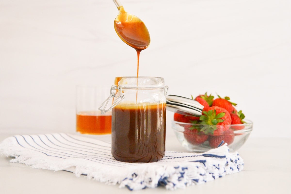 spoon with caramel sauce dripping off it 