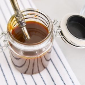 overhead close up of caramel sauce in glass jar