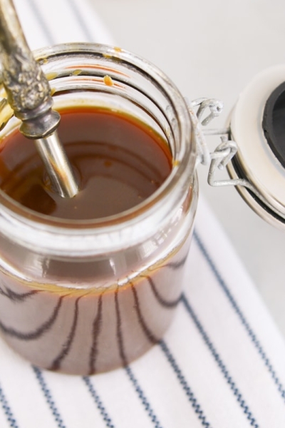 overhead close up of caramel sauce in glass jar