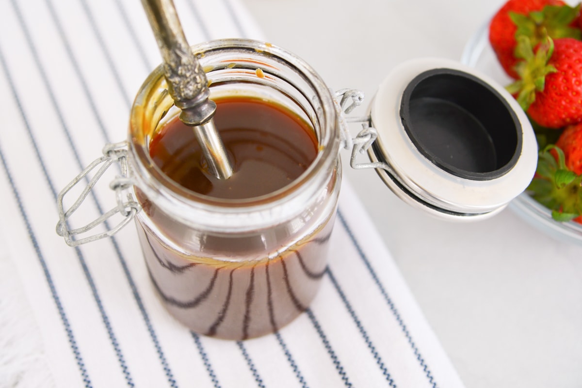 overhead close up of caramel sauce in glass jar