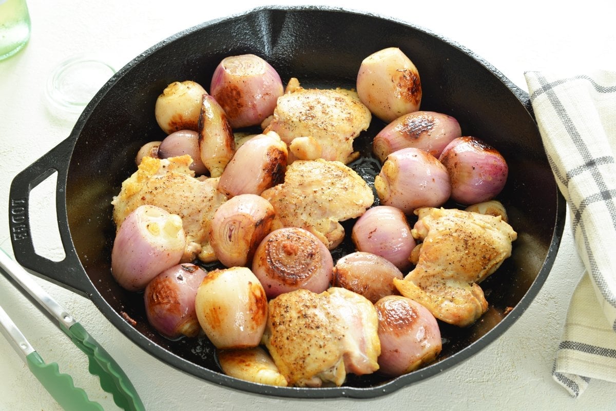 chicken and shallots in a skillet 