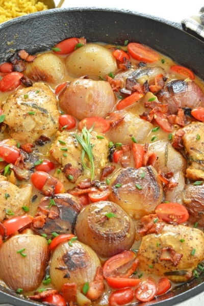 braised chicken thighs in a cast iron skillet