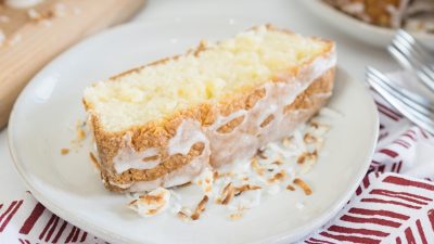 close up slice of coconut cream pound cake with drizzle