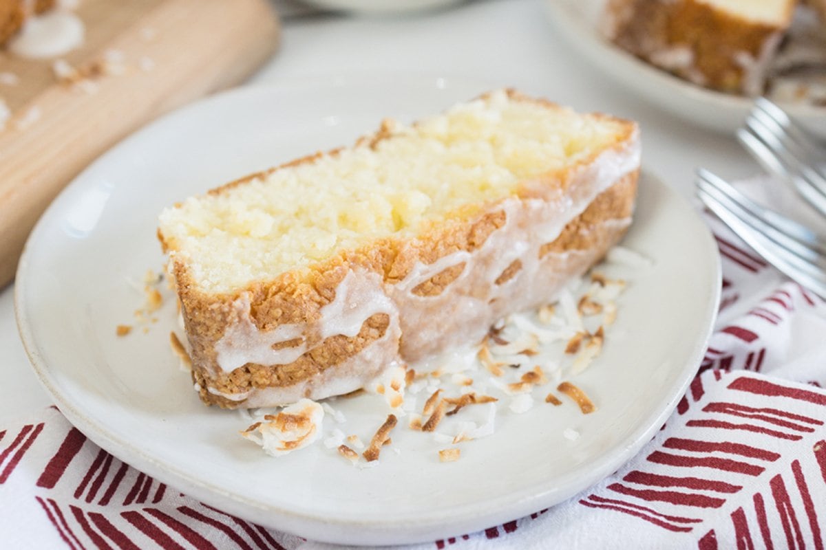 close up slice of coconut cream pound cake with drizzle