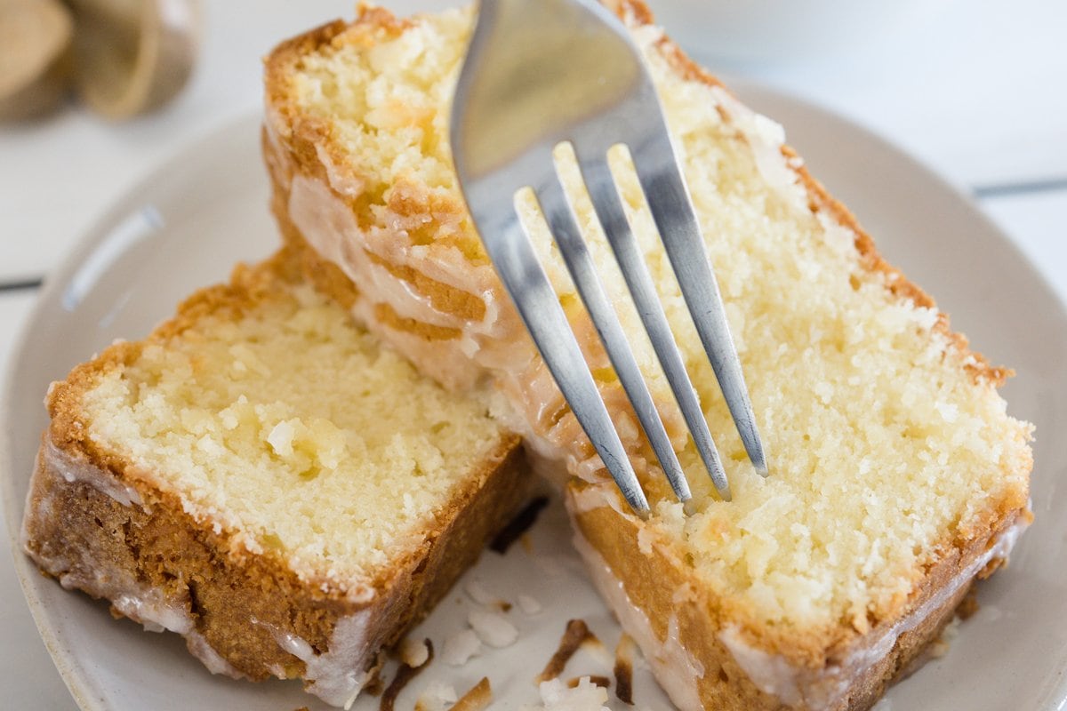 fork digging into a slice of coconut cream pound cake 