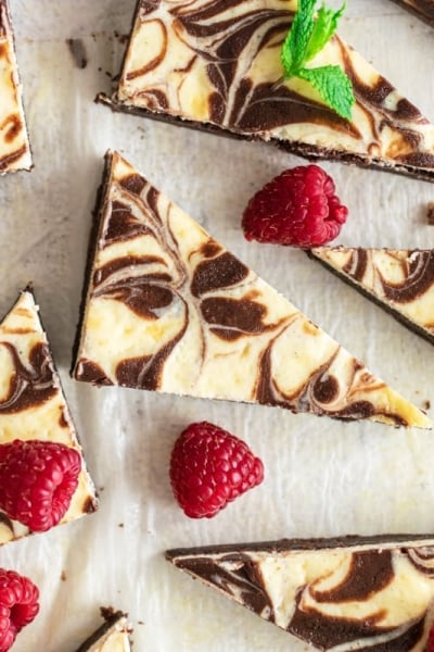 cut cream cheese brownies with fresh raspberries