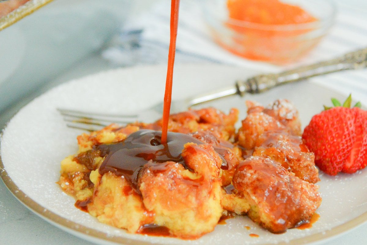 bourbon caramel pouring onto donut bread pudding  