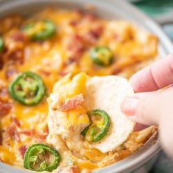 chip dipping into jalapeno popper dip