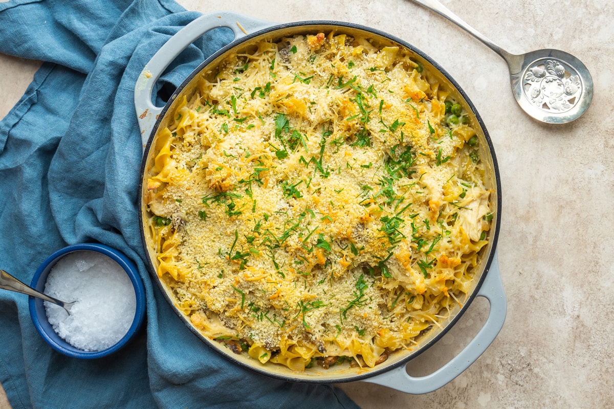 overhead of cheesy chicken tetrazzini casserole in blue enamel dish 