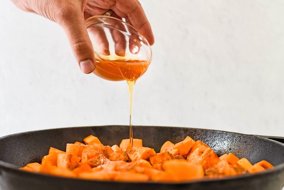 honey pouring over sweet potatoes 