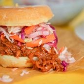 close up of a donut pulled pork sandwich