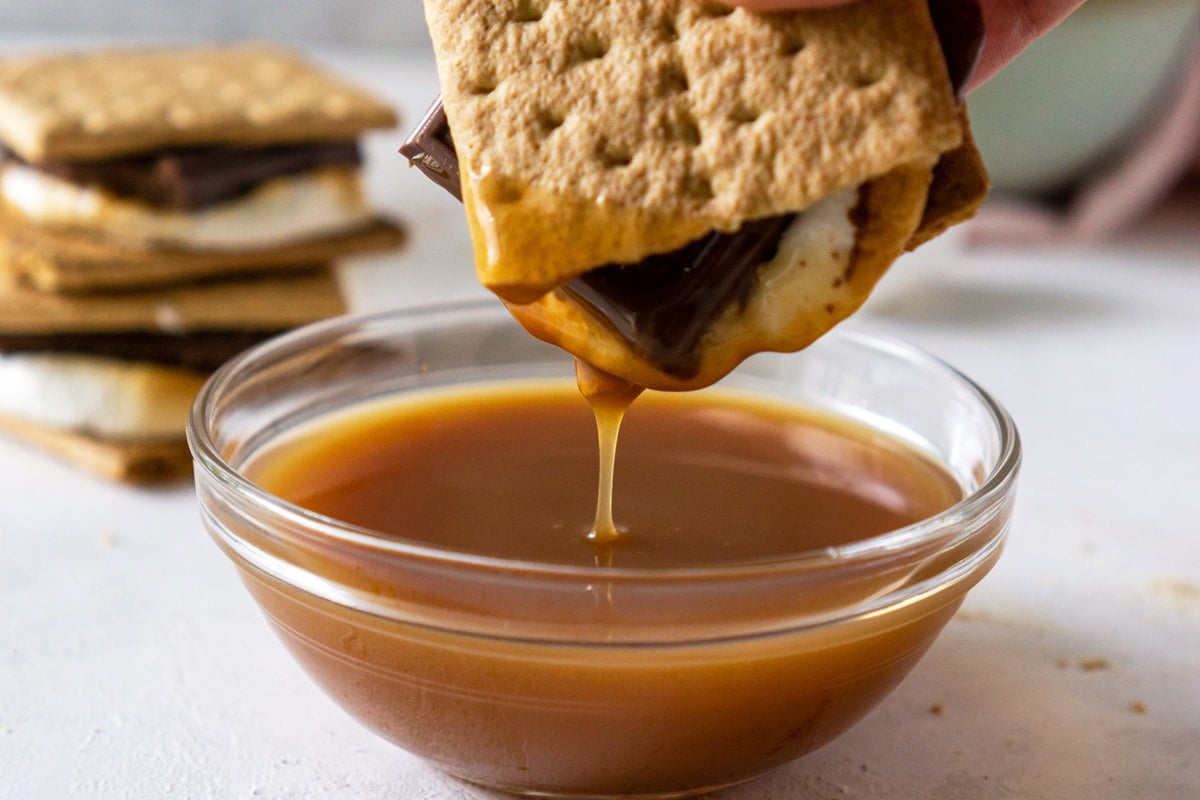 smore dipping into caramel sauce  