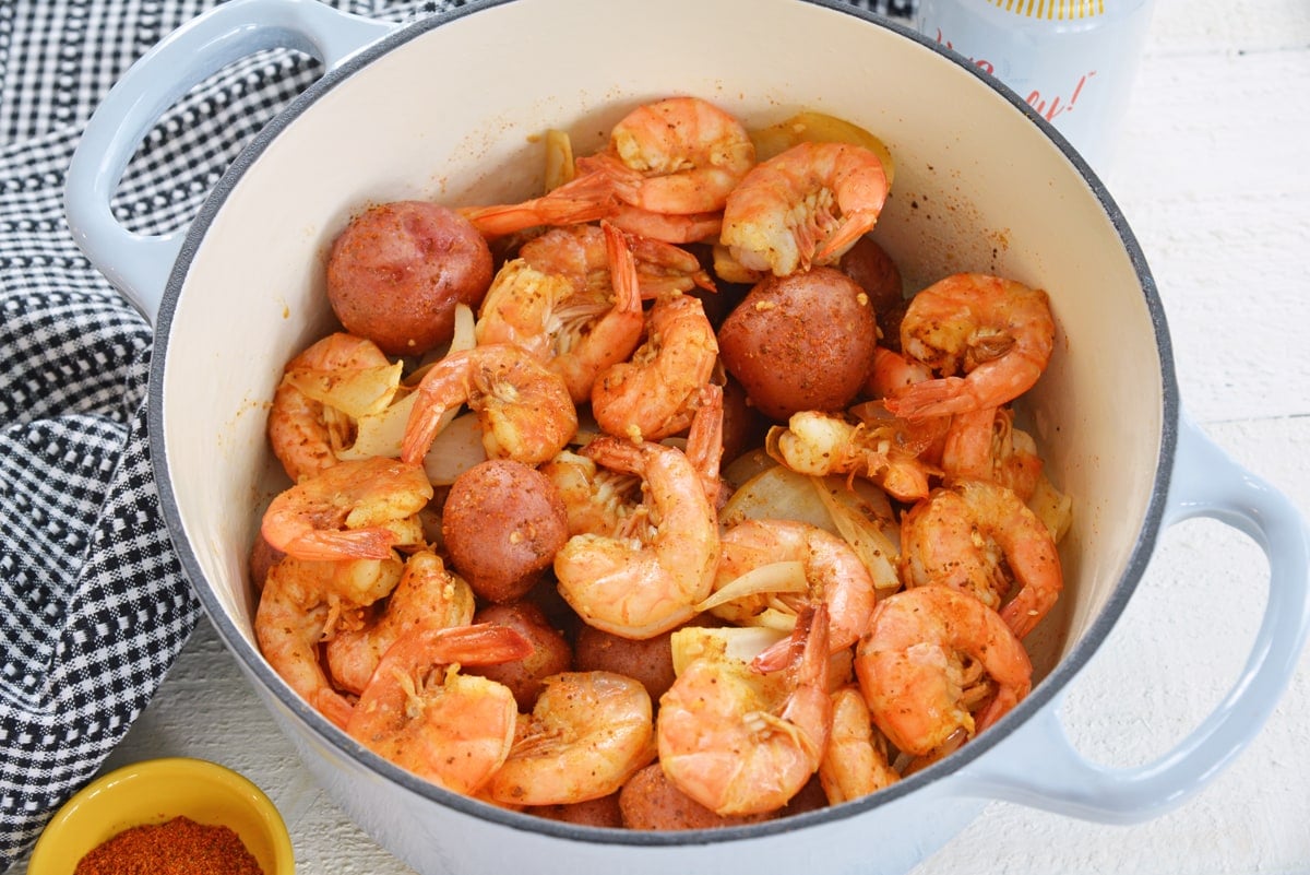 potatoes, shrimp and onions in a dutch oven 