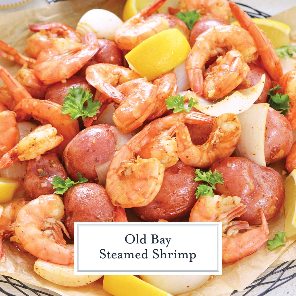 close up of steamed shrimp with lemons and onions and potatoes