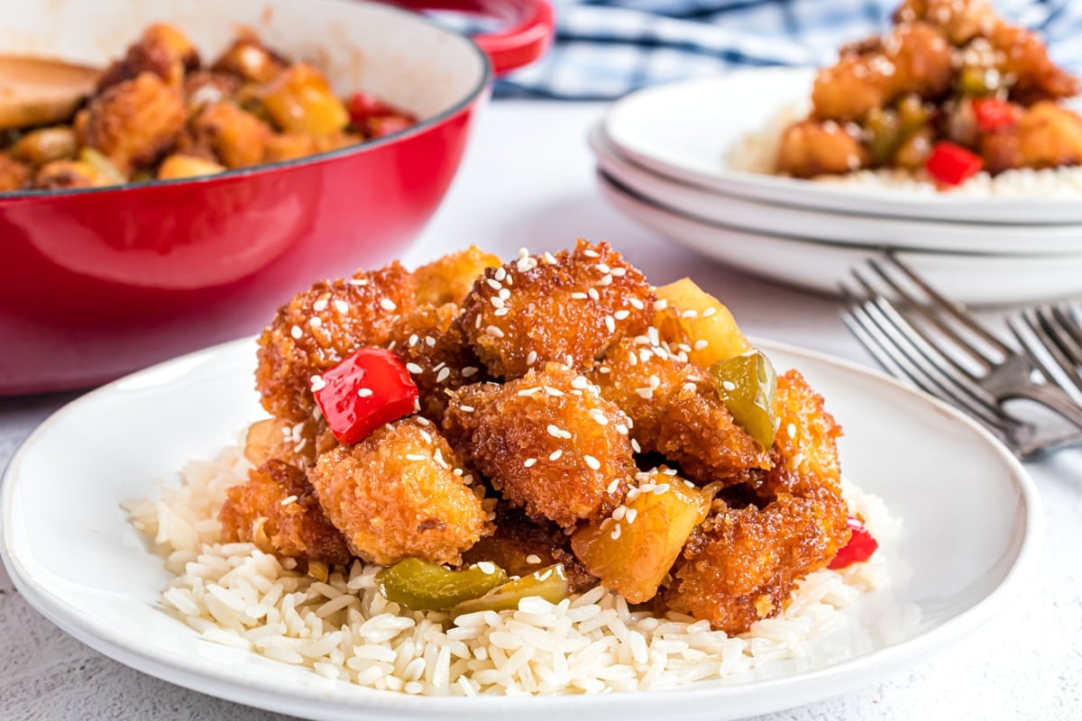 side view of sweet and sour chicken with sesame seeds 