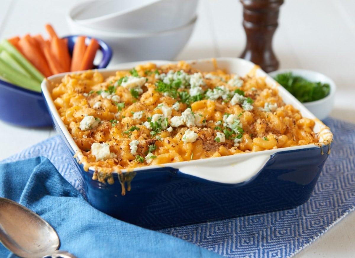 angle of creamy buffalo mac with carrots and celery sticks 