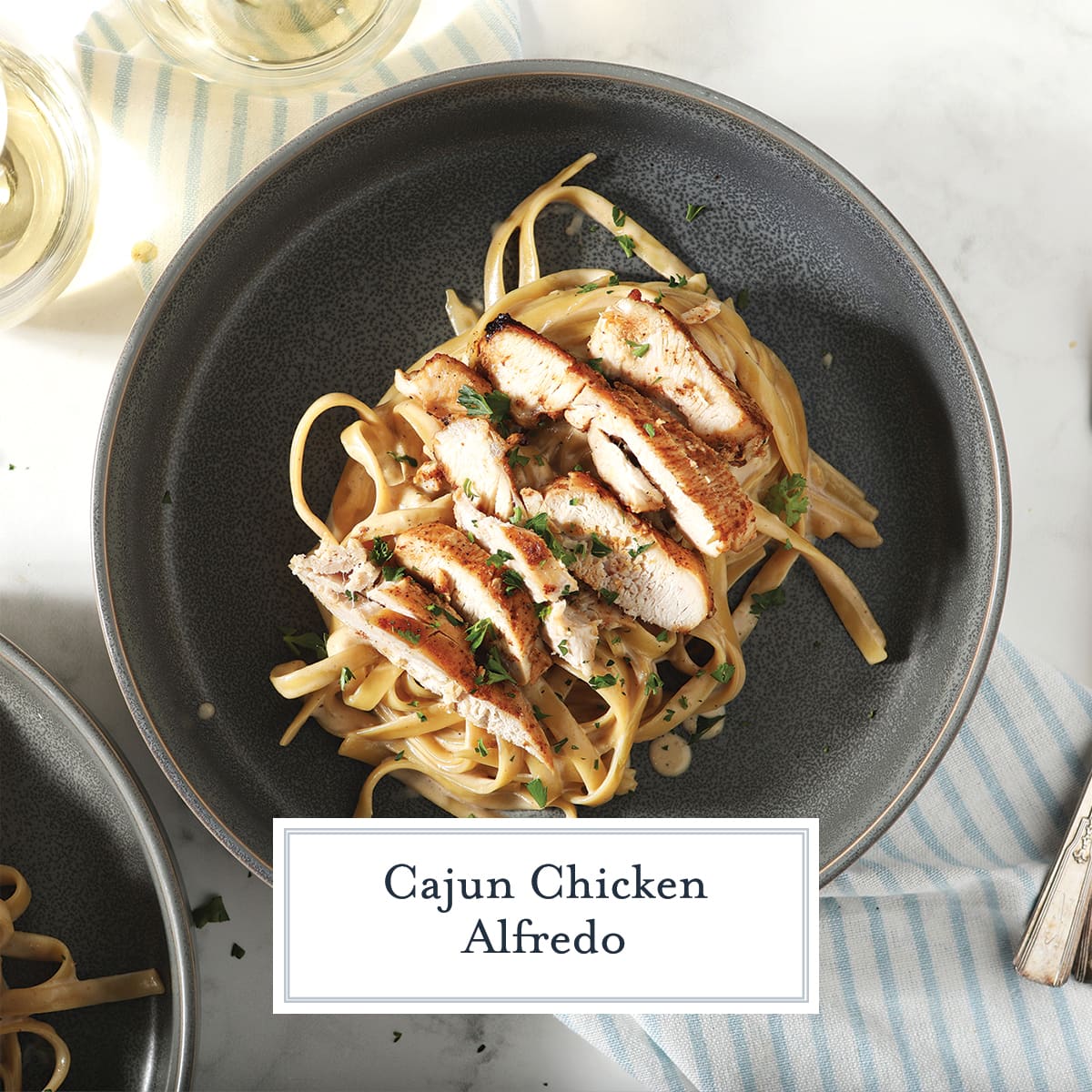 overhead of fettuccine alfredo on a black plate 