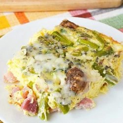 slice of ham and asparagus quiche on plate