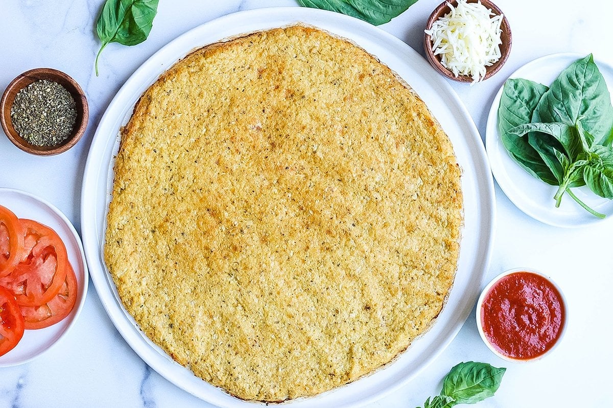 cooked cauliflower pizza crust in a circle 