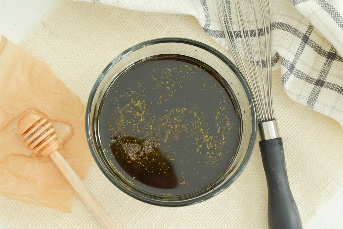 overhead of tomato salad dressing in a bowl with whisk 