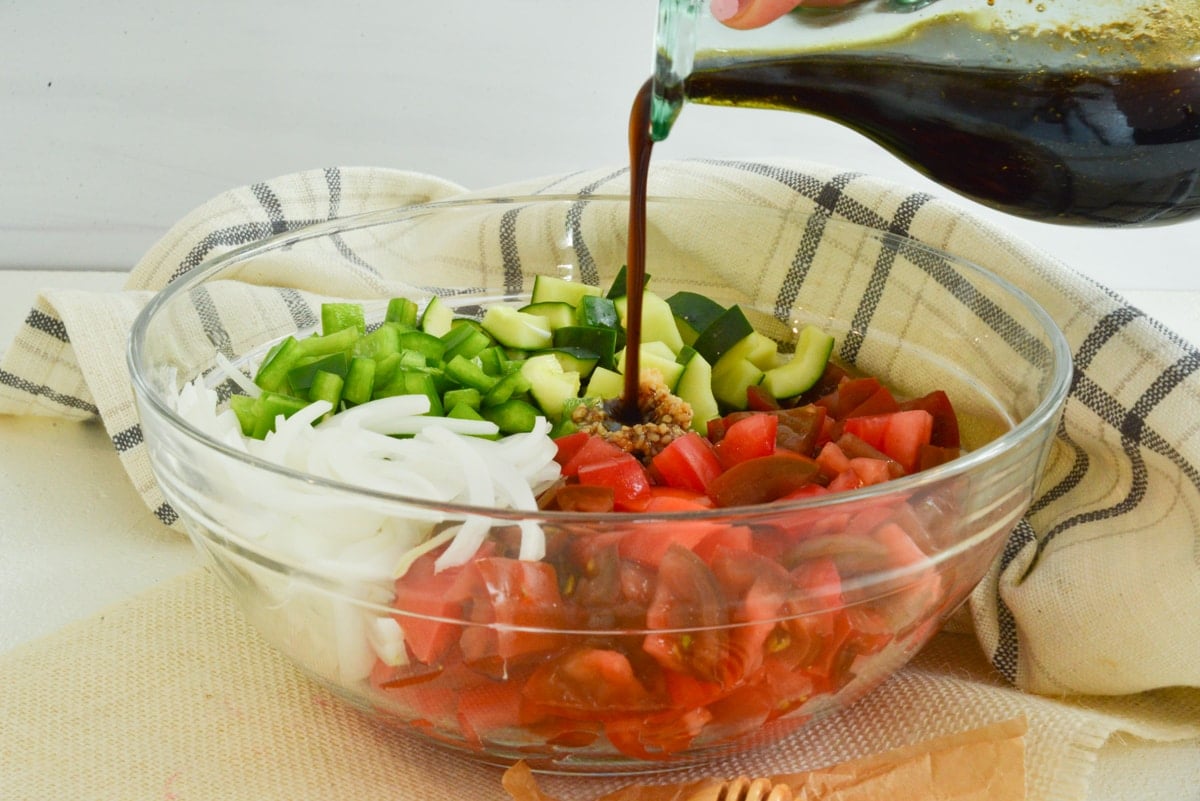 pouring dressing over salad 