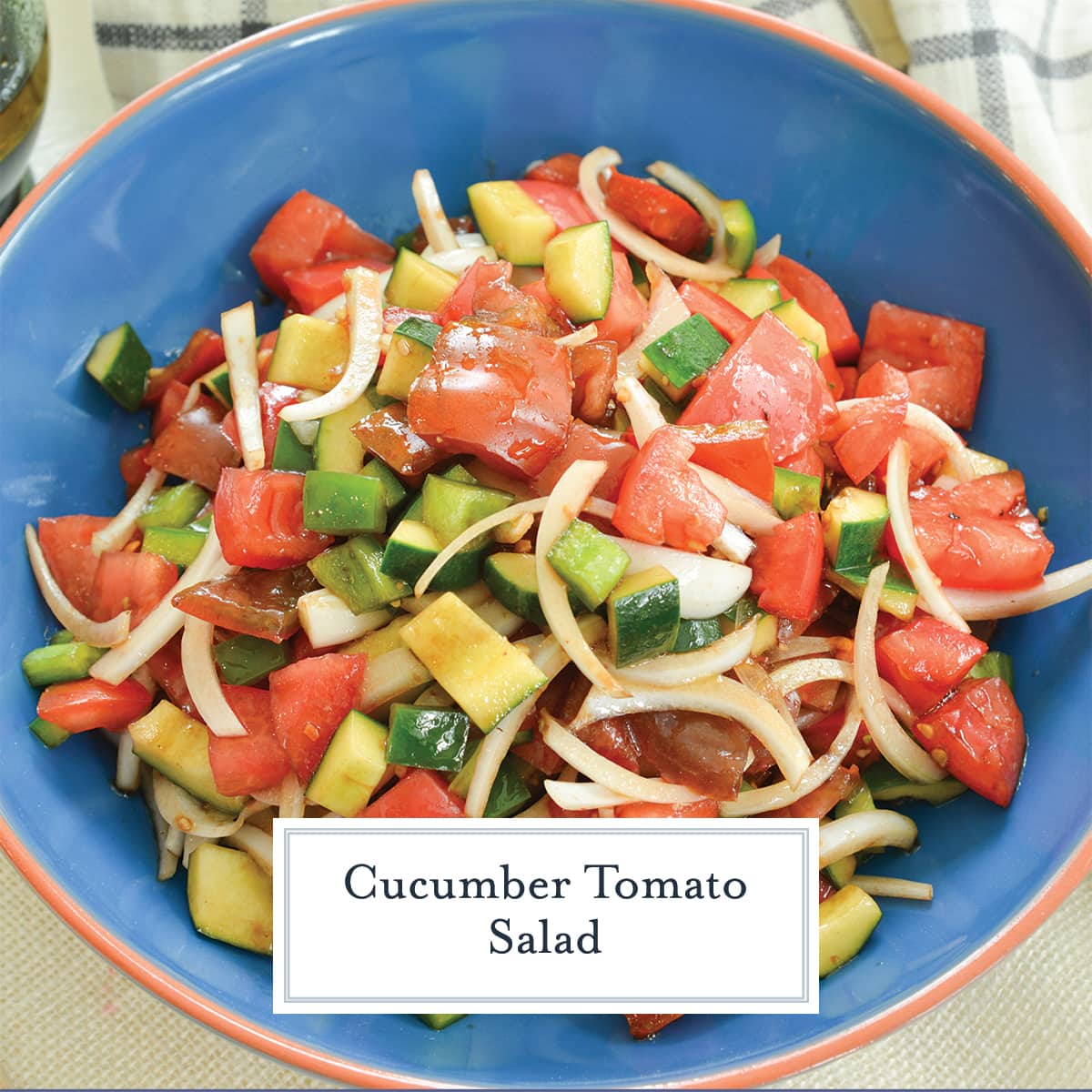 close up of tomato salad with dressing in a blue bowl