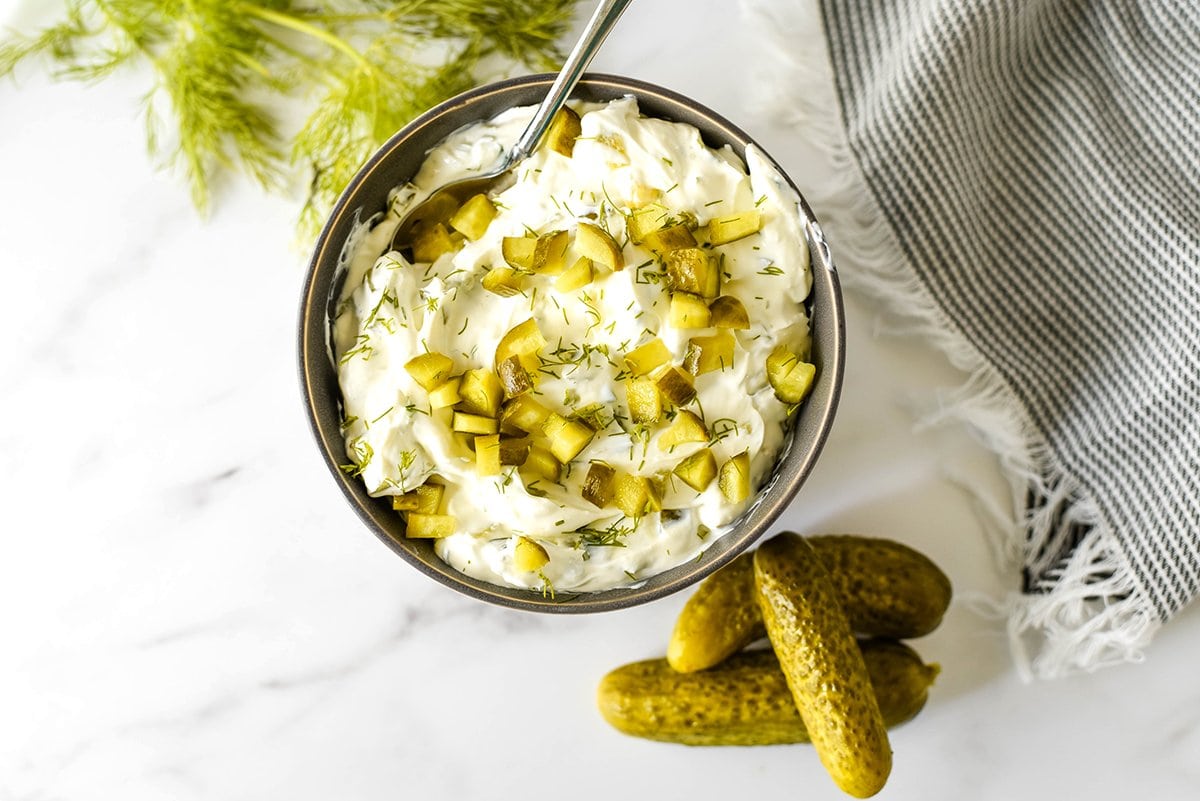 creamy dill pickle dip with fresh herbs and pickles 