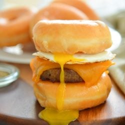 donut breakfast sandwich with drippy egg yolk