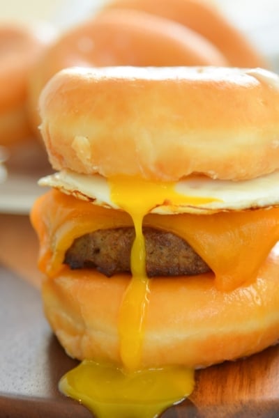 donut breakfast sandwich with drippy egg yolk